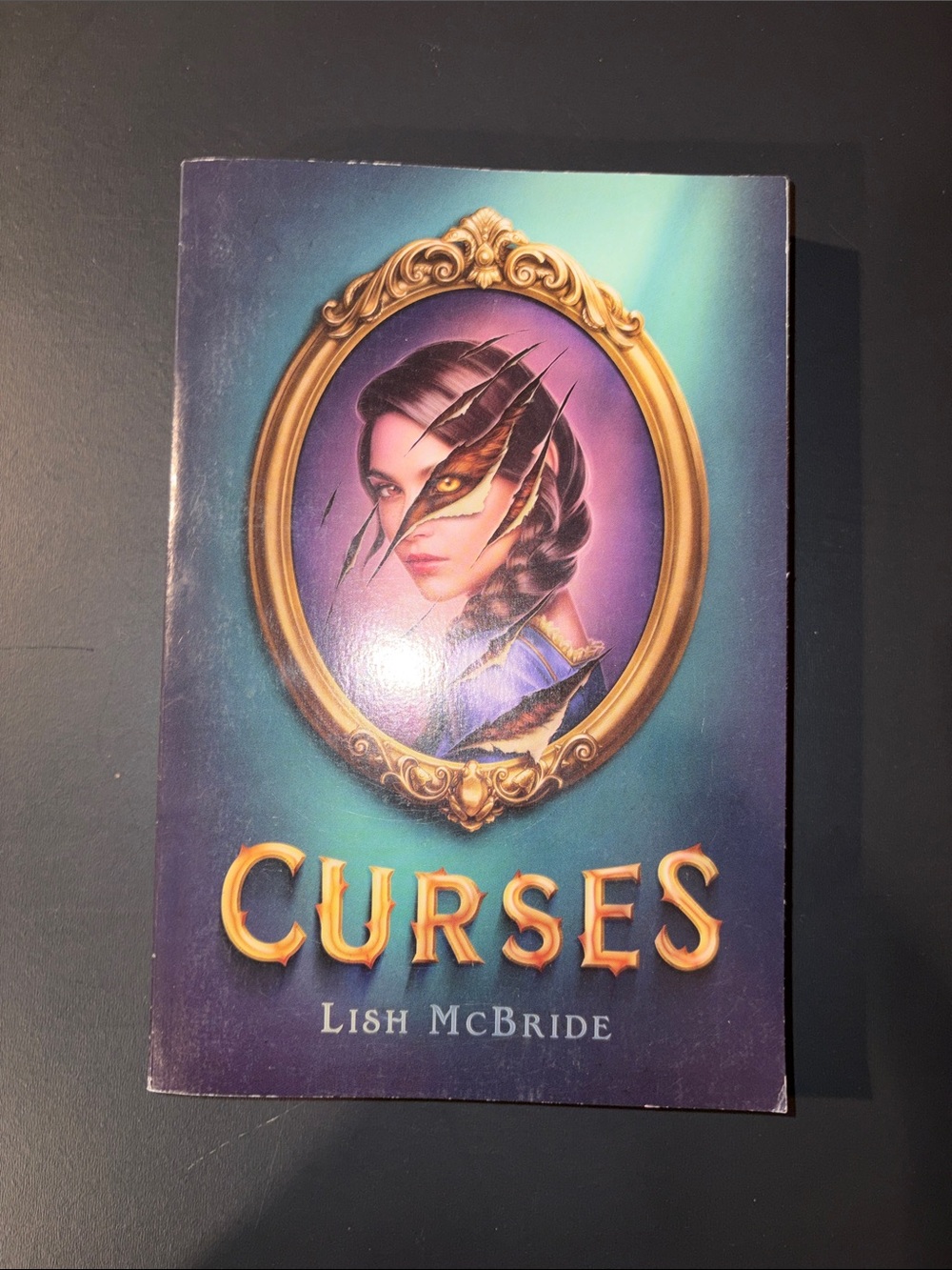 Scholastic Purple and Teal "Curses" Paperback by Lish McBride